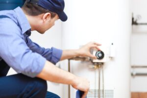 Service Technician Adjusting Water Heater